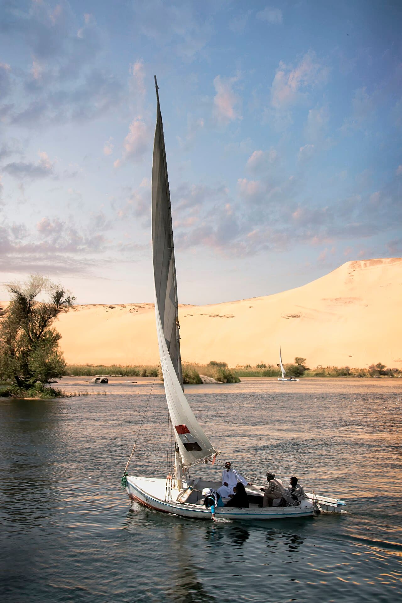 A felucca sailboat on the Nile near Aswan at golden hour
