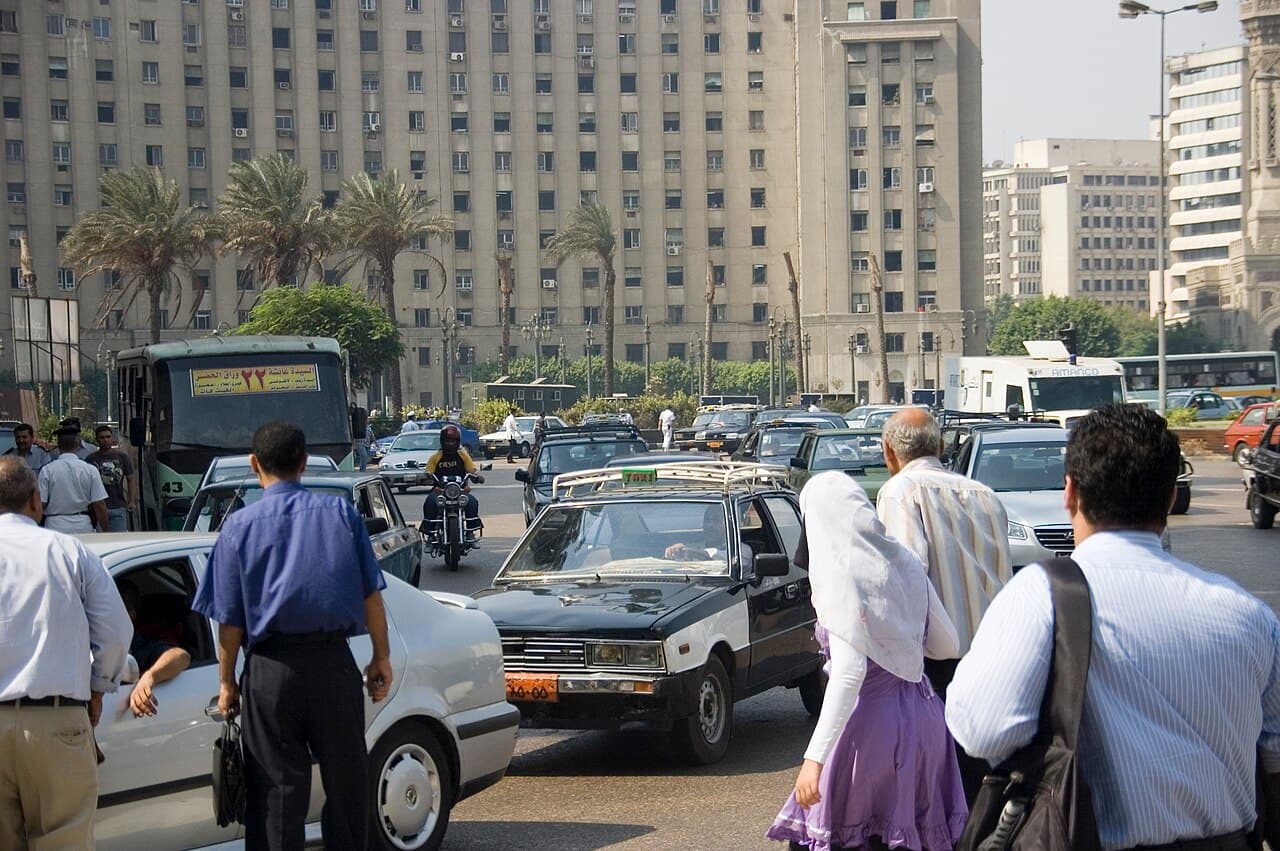A black-and-white taxi in central Cairo traffic