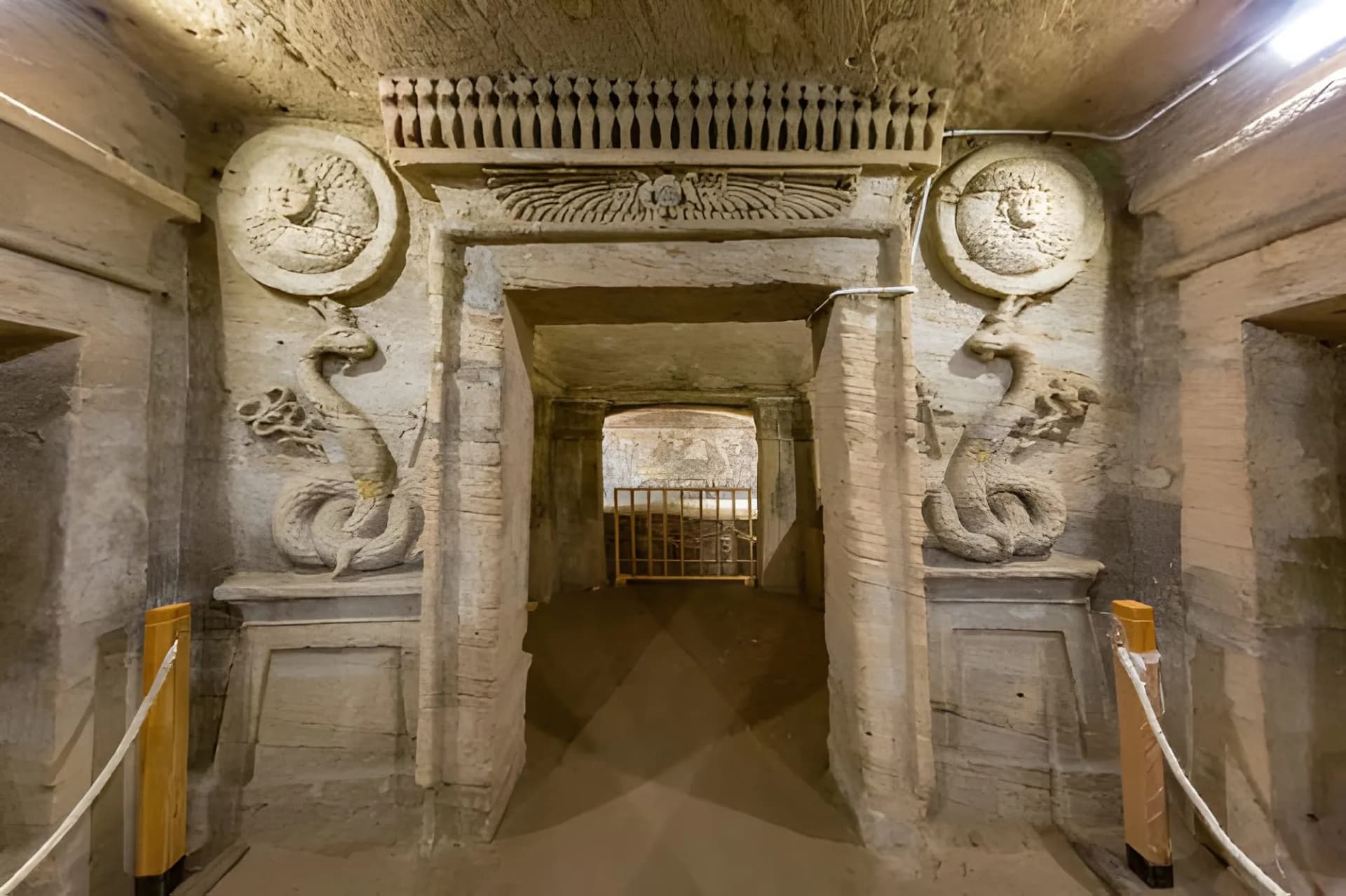 A carved doorway with serpent reliefs inside the Catacombs of Kom El Shoqafa