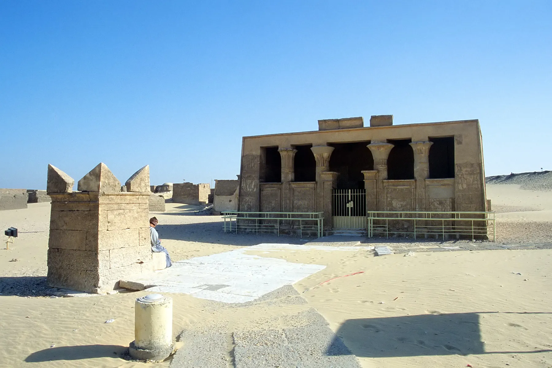 The tomb of Petosiris at Tuna el-Gebel, seen across the desert sand