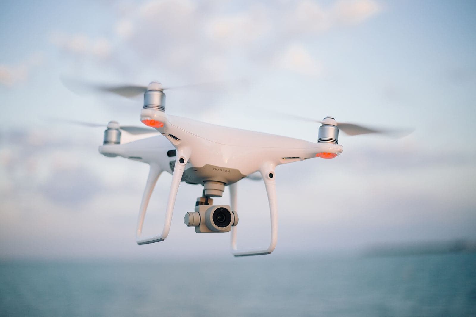 A quadcopter camera drone in flight